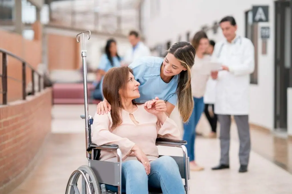 Nurse greeting patient on a wheelchair